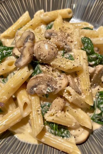 creamy mushroom pasta with Spinach and Mushrooms taken with iphone 15 pro max --iw 2 --ar 4:5 --v 6.0 --raw