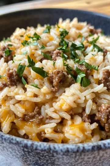ground beef and rice with Cheddar and Parmesan taken with iphone 15 pro max --iw 2 --ar 4:5 --v 6.1 --raw