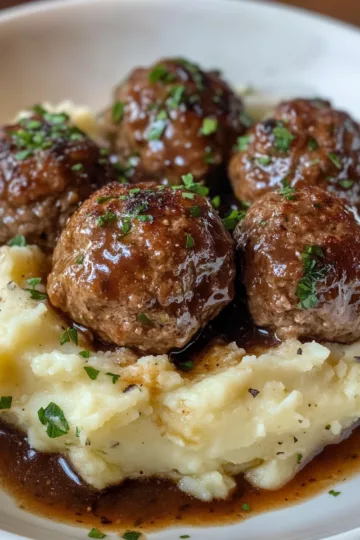 Salisbury Steak Meatballs with Garlic Herb Mashed Potatoes taken with iphone 15 pro max --iw 2 --ar 4:5 --v 6.1 --raw