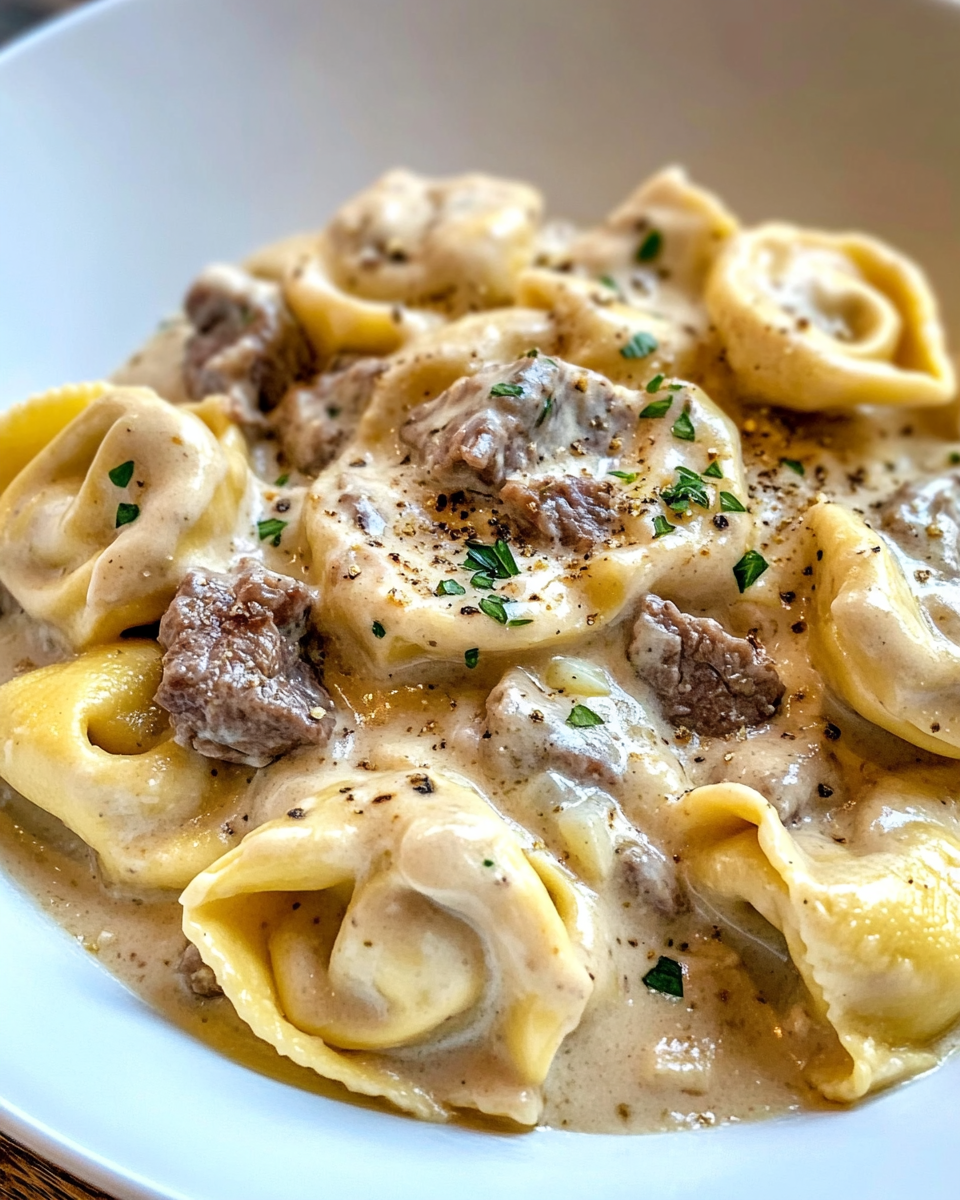 Ingredients for cheesesteak tortellini including beef, stock, cheeses, and tortellini