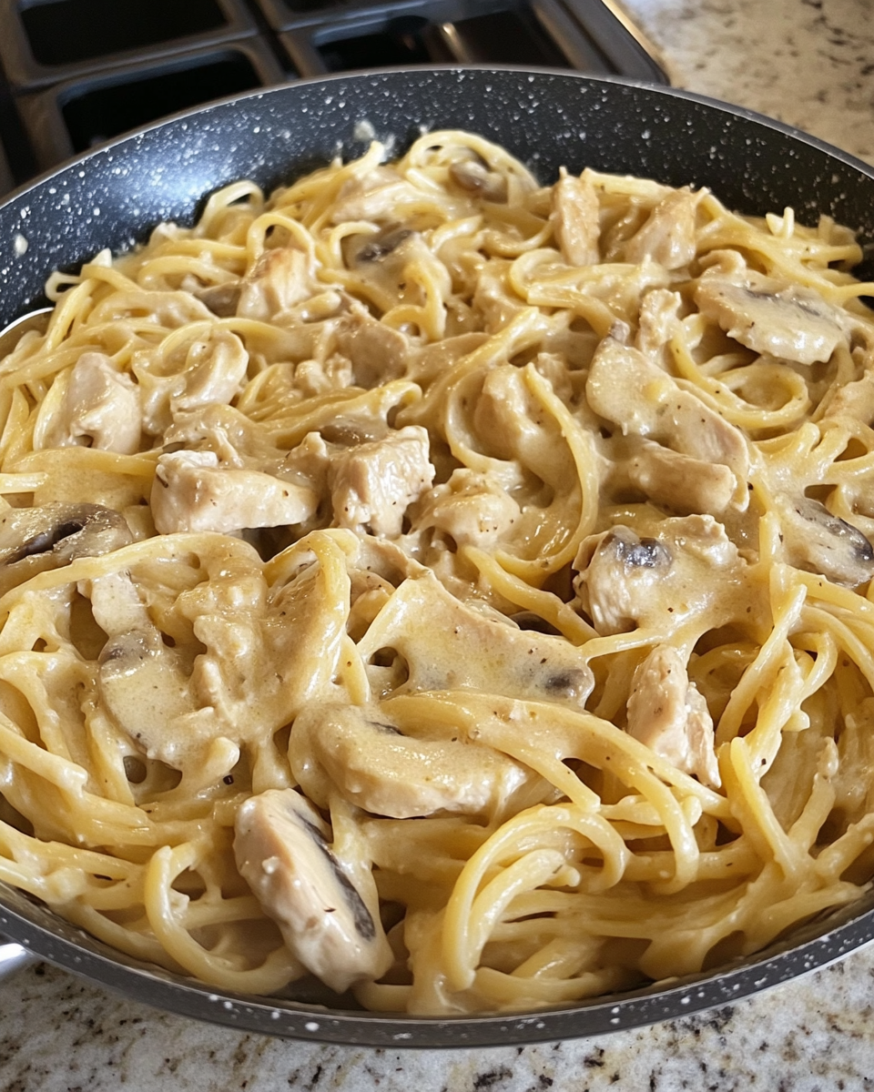 Pressure cooker steam rising as creamy chicken tetrazzini cooks