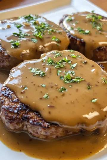 hamburger steaks with brown gravy taken with iphone 15 pro max --iw 2 --ar 4:5 --v 6.1 --raw