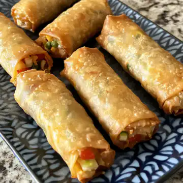 Air Fried Tofu Veggie Spring Rolls taken with iphone 15 pro max --iw 2 --ar 4:5 --v 6.1 --raw