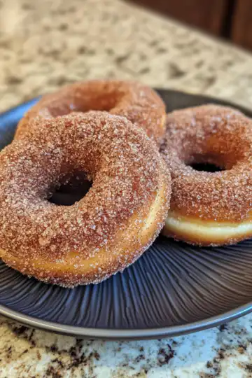 Baked Cinnamon Crunch Apple Cider Doughnuts taken with iphone 15 pro max --iw 2 --ar 4:5 --v 6.1 --raw