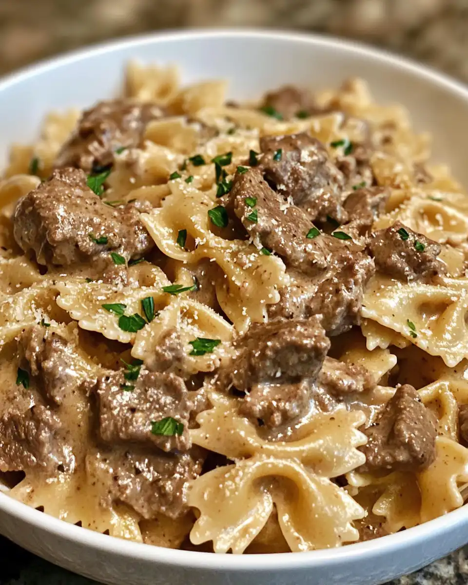 Ingredients including sliced andouille sausage, mushrooms, peppers, and gluten-free penne pasta