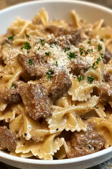creamy parmesan garlic beef bowtie pasta crisp tastes taken with iphone 15 pro max --iw 2 --ar 4:5 --v 6.1 --raw