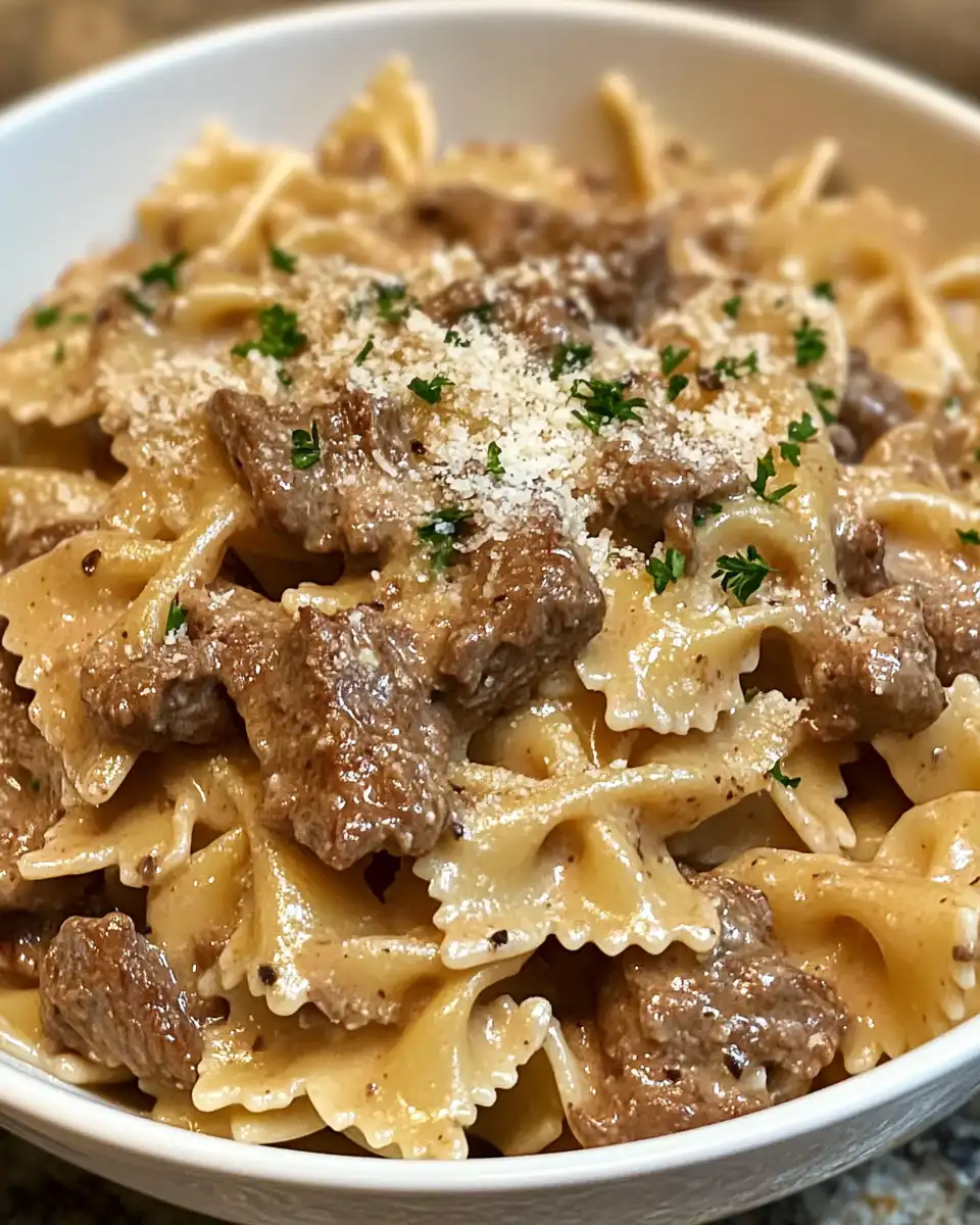 Pressure cooker steam rising as creamy Parmesan garlic beef bowtie pasta cooks