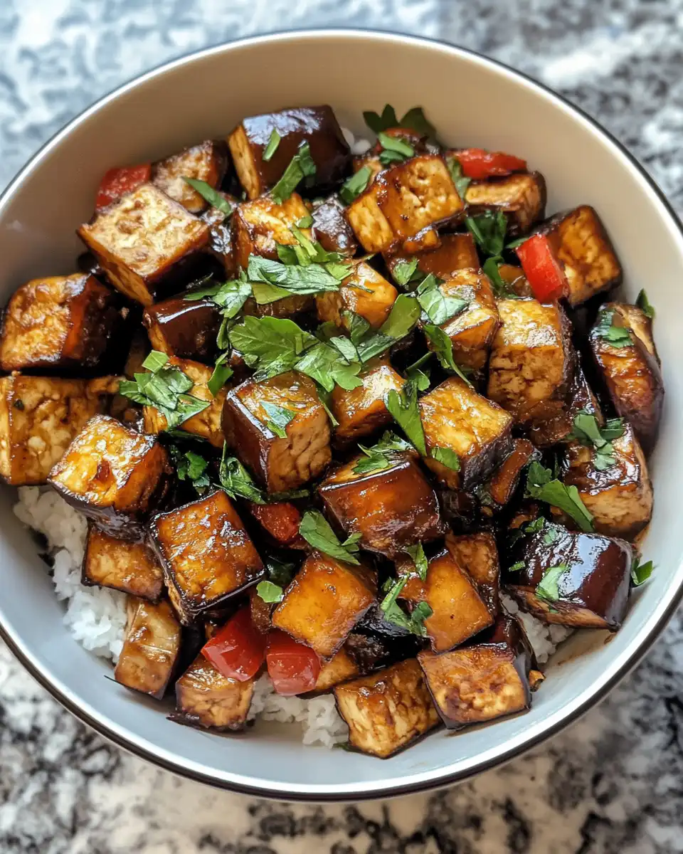 Ingredients for eggplant and tofu dish including tofu, eggplants, and chili sauce