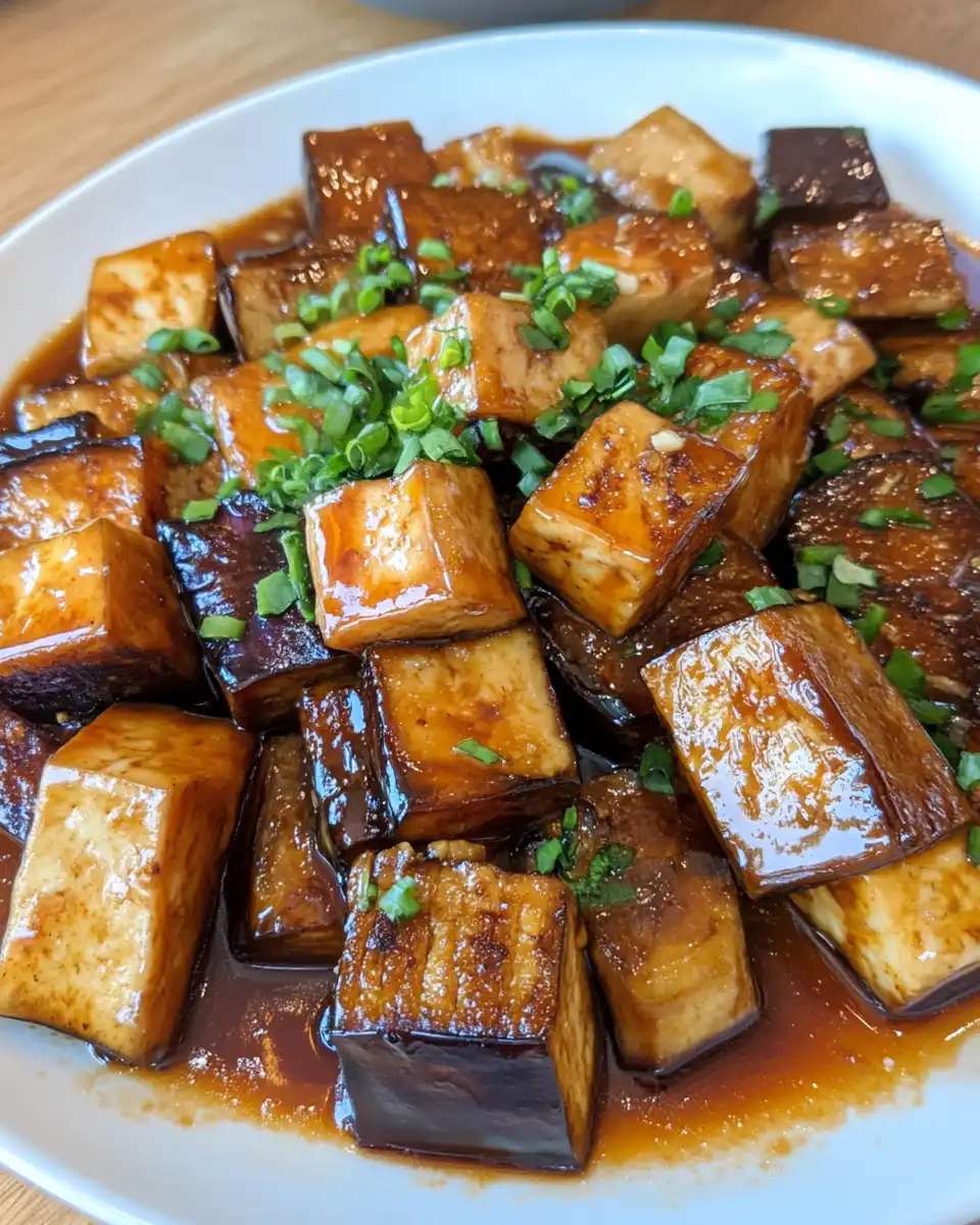 Ingredients laid out for eggplant tofu adobo including tofu, eggplants, soy sauce, and vinegar