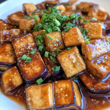 Famous Eggplant Tofu taken with iphone 15 pro max --iw 2 --ar 4:5 --v 6.1 --raw