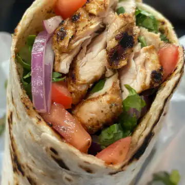 Grilled Chicken Shawarma Wrap taken with iphone 15 pro max --iw 2 --ar 4:5 --v 6.1 --raw