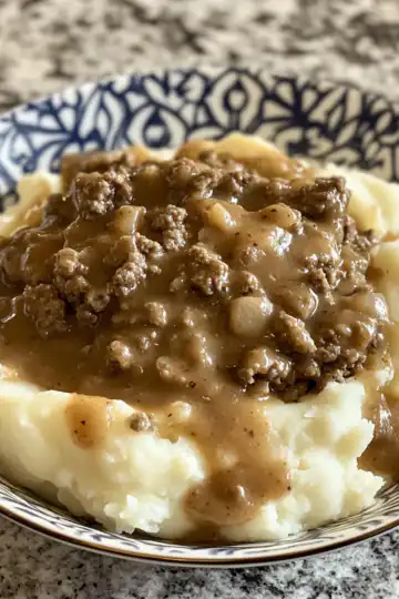 ground beef and gravy over mashed potatoes cookedbymomy taken with iphone 15 pro max --iw 2 --ar 4:5 --v 6.1 --raw