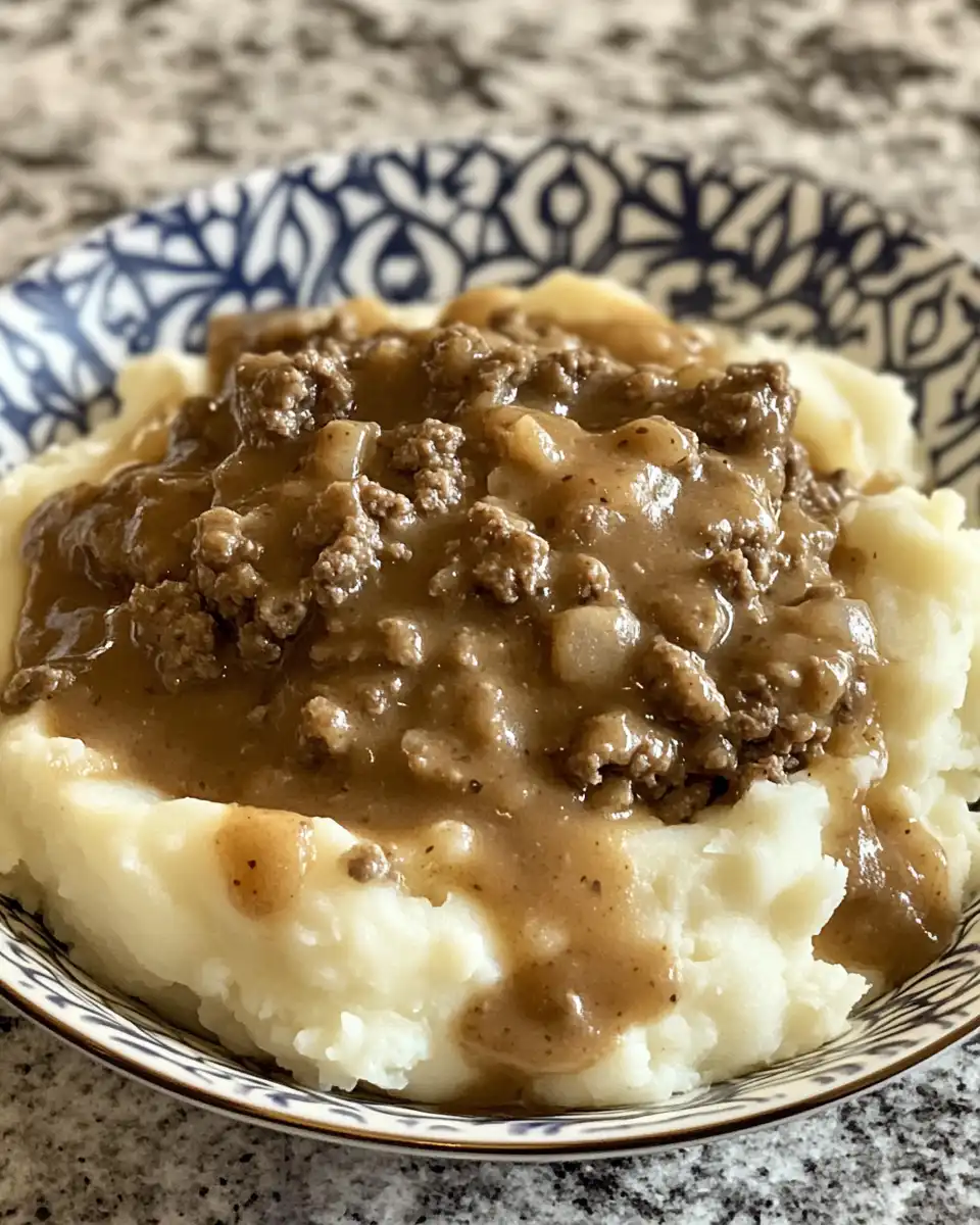 Close-up of ground beef and gravy over mashed potatoes, fresh from the cooker