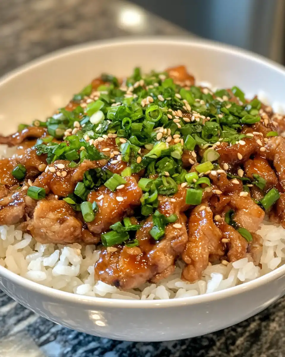 Final honey garlic pork rice bowl serving with vibrant toppings