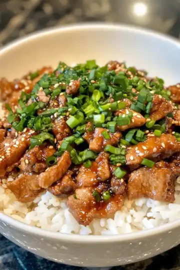 honey garlic pork rice bowl taken with iphone 15 pro max --iw 2 --ar 4:5 --v 6.1 --raw