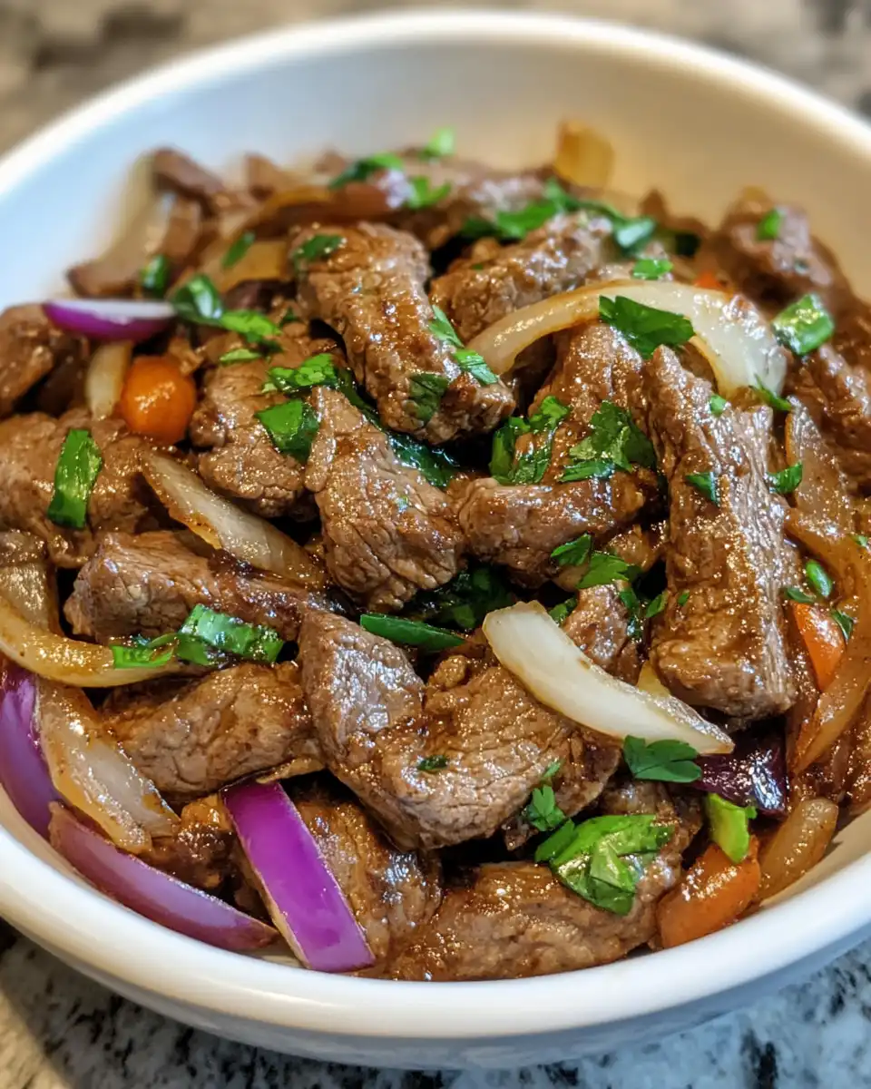 Ingredients including sliced onion, bell peppers, soy sauce and spices ready for pepper steak