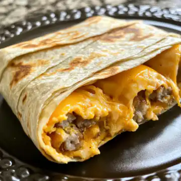 Melted Cheddar Cheesy Sausage Egg Wraps taken with iphone 15 pro max --iw 2 --ar 4:5 --v 6.1 --raw