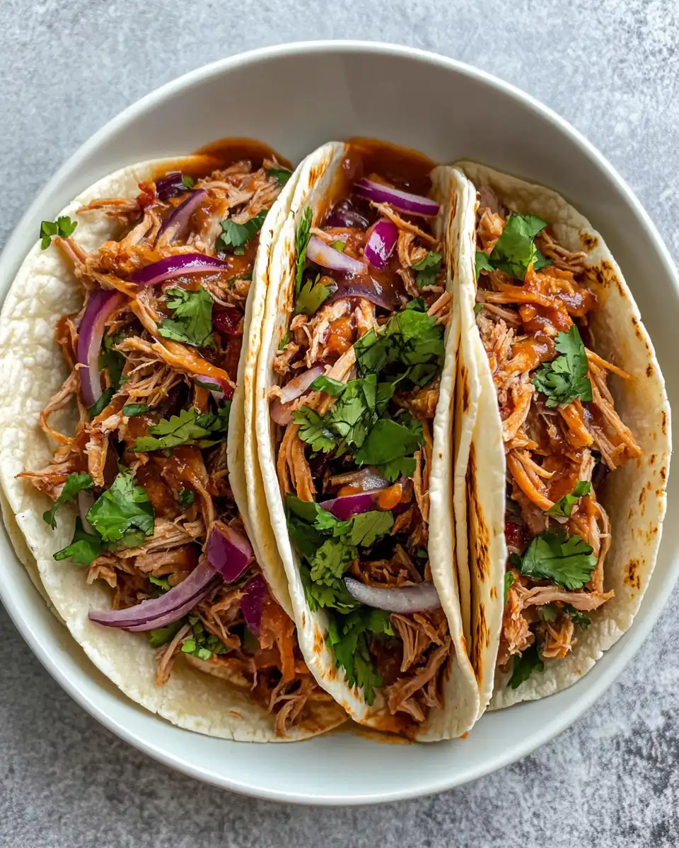 Slow cooker pulled pork tacos steaming fresh from the cooker