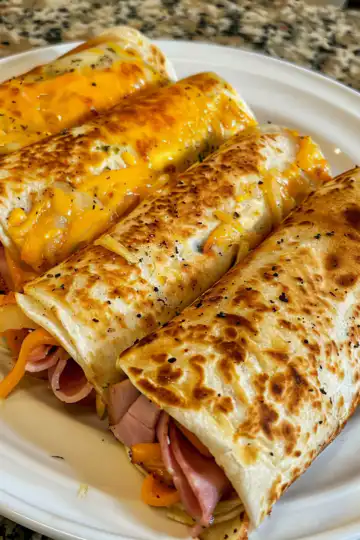 Air Fryer Ham and Cheese Wraps taken with iphone 15 pro max --iw 2 --ar 4:5 --v 6.0 --raw