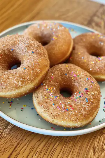 Apple Cinnamon Baked Doughnuts taken with iphone 15 pro max --iw 2 --ar 4:5 --v 6.0 --raw