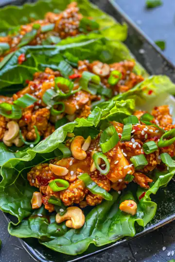 Sweet And Spicy Cashew Chili Lettuce Wraps taken with iphone 15 pro max --iw 2 --ar 4:5 --v 6.0 --raw