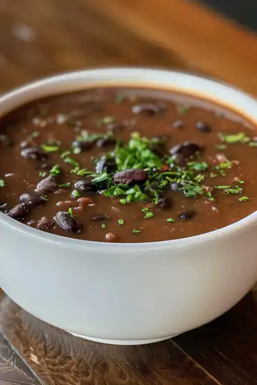 Vegan Black Bean Soup taken with iphone 15 pro max --iw 2 --ar 4:5 --v 6.0 --raw