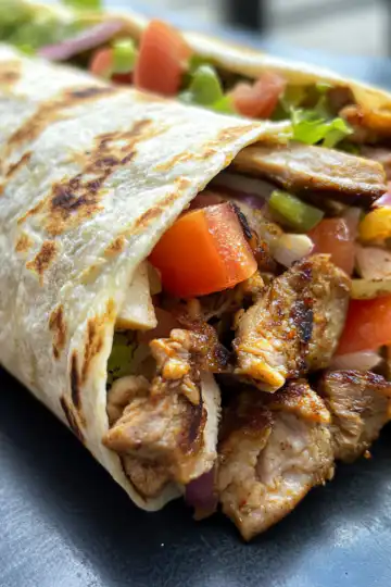 Chicken Shawarma Wrap taken with iphone 15 pro max --iw 2 --ar 4:5 --v 6.1 --raw
